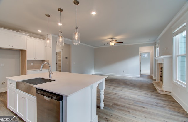 kitchen with dishwasher, ceiling fan, white cabinetry, and an island with sink