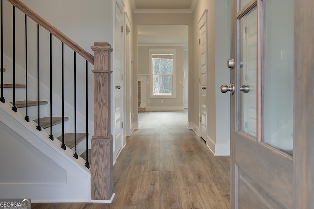 interior space with light hardwood / wood-style floors and ornamental molding