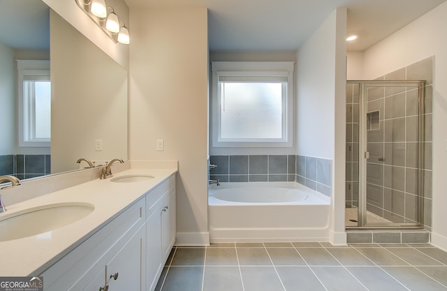 bathroom featuring tile patterned flooring, vanity, and separate shower and tub