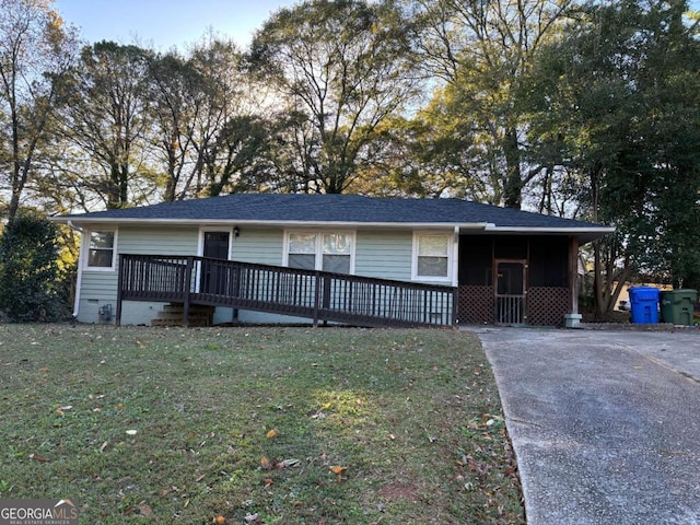 view of front of house featuring a front yard and a wooden deck