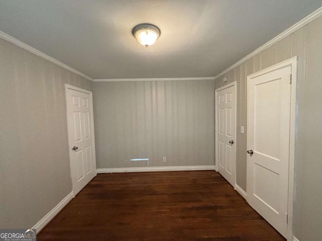 spare room featuring crown molding and dark wood-type flooring