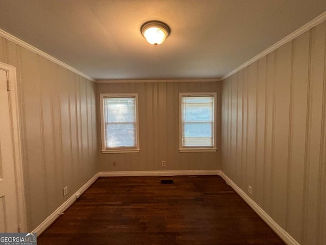 empty room with crown molding and dark hardwood / wood-style floors