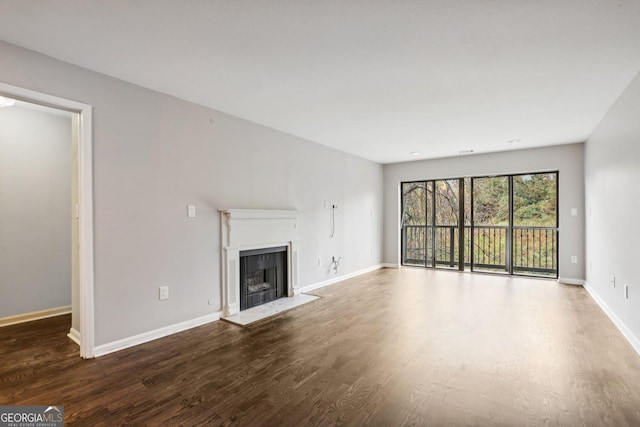 unfurnished living room with dark hardwood / wood-style flooring