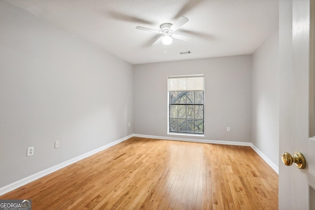 unfurnished room with ceiling fan and light wood-type flooring