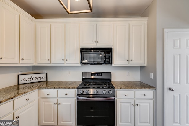 kitchen featuring white cabinetry, gas range, and stone counters