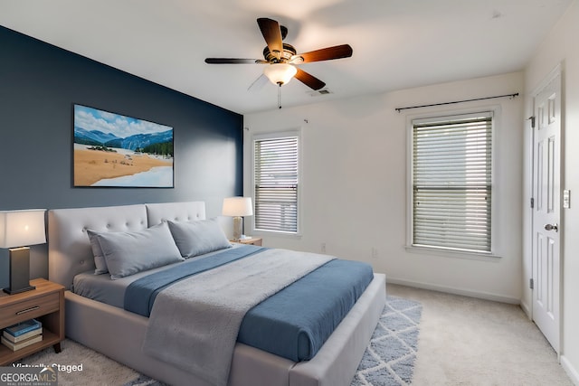 bedroom with light carpet and ceiling fan