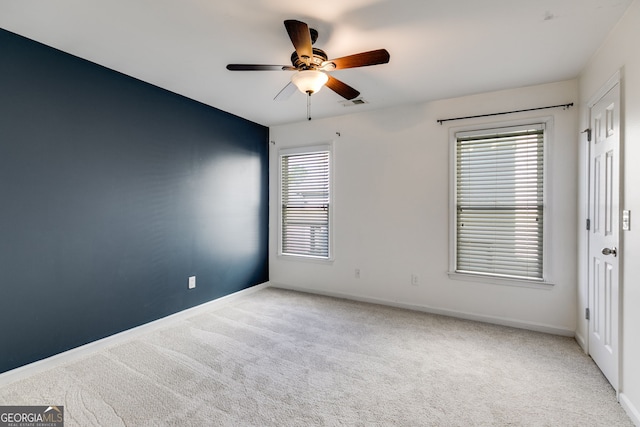 carpeted empty room featuring ceiling fan