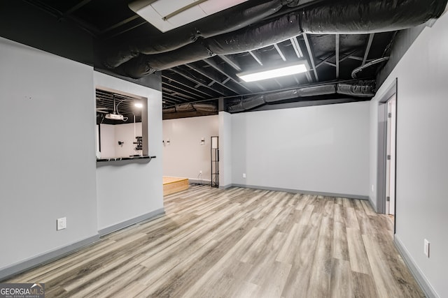 basement featuring hardwood / wood-style floors