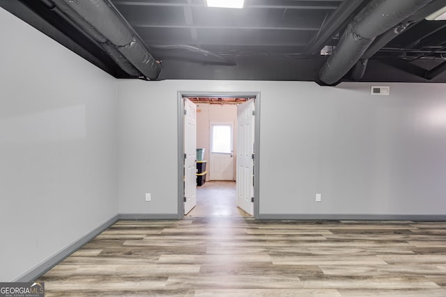 empty room with light hardwood / wood-style flooring