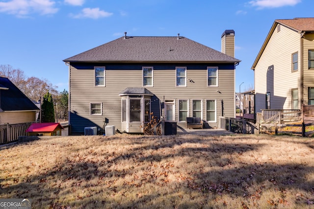 rear view of property featuring central AC unit