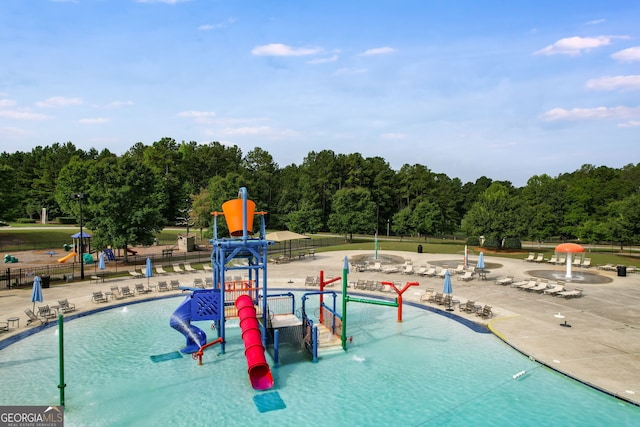 view of pool featuring a playground