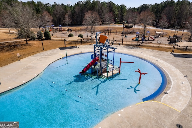 view of pool with a playground