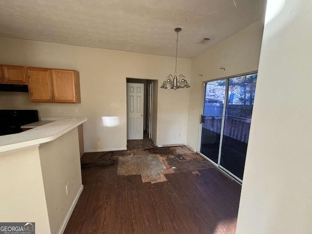 unfurnished dining area with dark wood-type flooring and an inviting chandelier