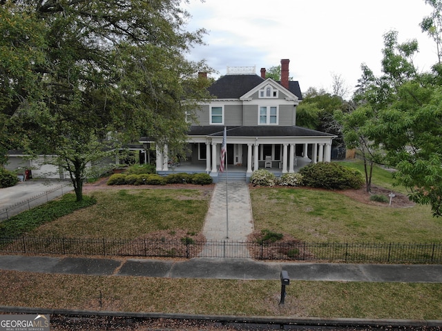 view of front of home with covered porch and a front yard