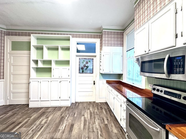 kitchen featuring dark wood-type flooring, ornamental molding, stainless steel appliances, and white cabinetry