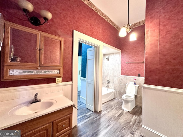 bathroom with toilet, wood-type flooring, and vanity