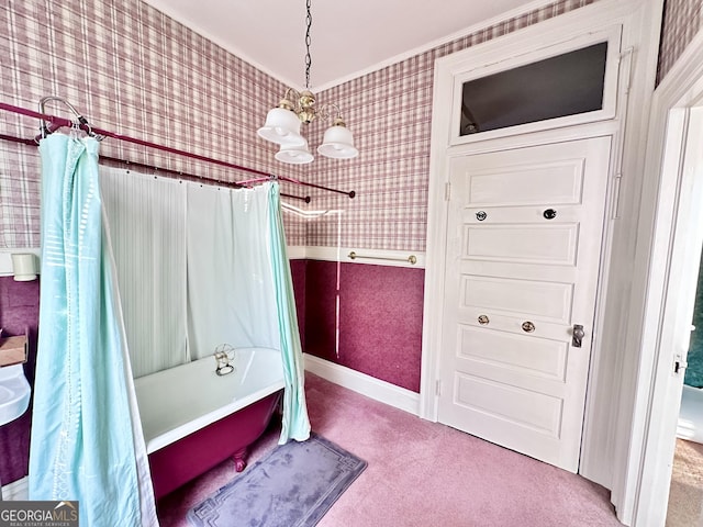 bathroom featuring an inviting chandelier, ornamental molding, and shower / bath combo with shower curtain