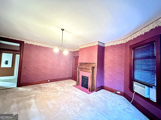 unfurnished living room featuring light colored carpet, cooling unit, and a notable chandelier