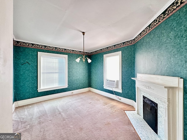 unfurnished living room featuring cooling unit, a chandelier, a fireplace, and carpet floors