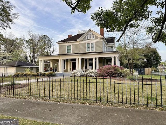 view of front of house featuring a front lawn and covered porch