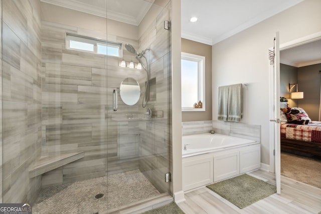 bathroom featuring independent shower and bath, ornamental molding, and hardwood / wood-style flooring