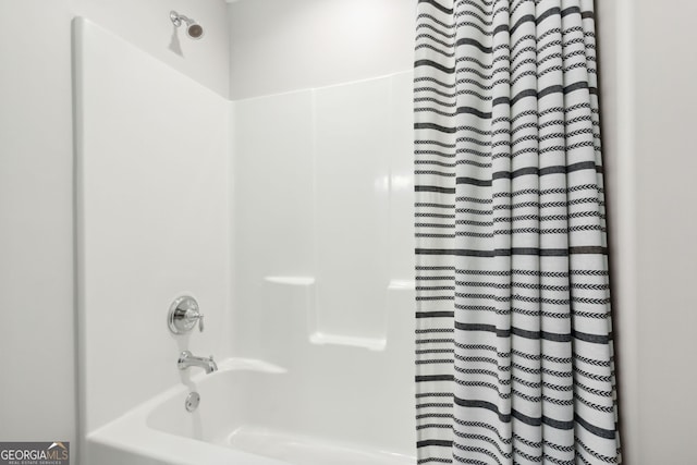 bathroom with shower / bath combo with shower curtain