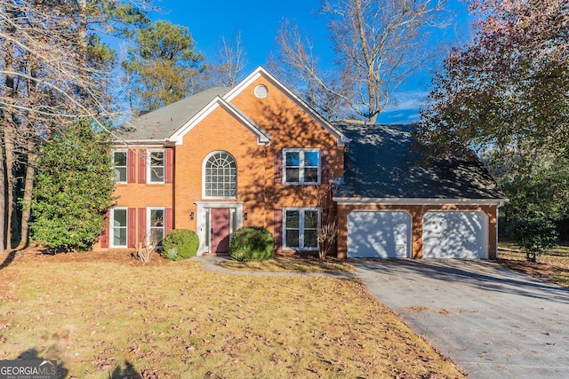 view of front of property with a garage and a front lawn