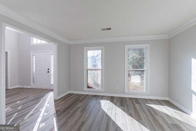 foyer entrance featuring crown molding, dark hardwood / wood-style flooring, and a textured ceiling