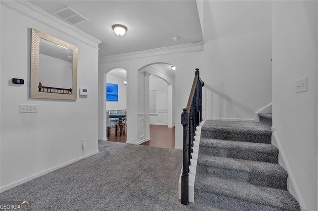 stairway featuring carpet floors and ornamental molding