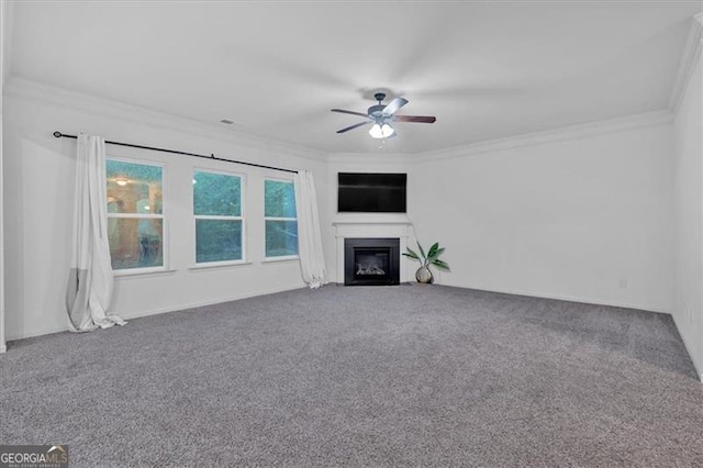 unfurnished living room featuring carpet flooring, ceiling fan, and ornamental molding