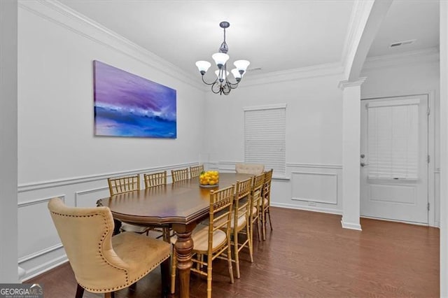 dining area with dark hardwood / wood-style floors, ornamental molding, and a chandelier