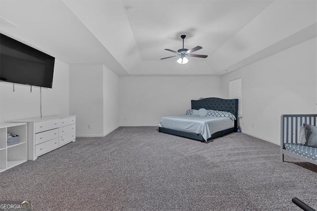 unfurnished bedroom with ceiling fan, a raised ceiling, and carpet floors