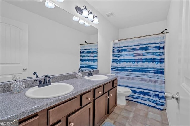 bathroom featuring a shower with curtain, vanity, and toilet