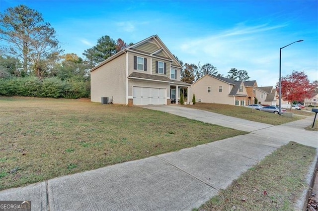 view of front of home featuring central air condition unit, a front yard, and a garage