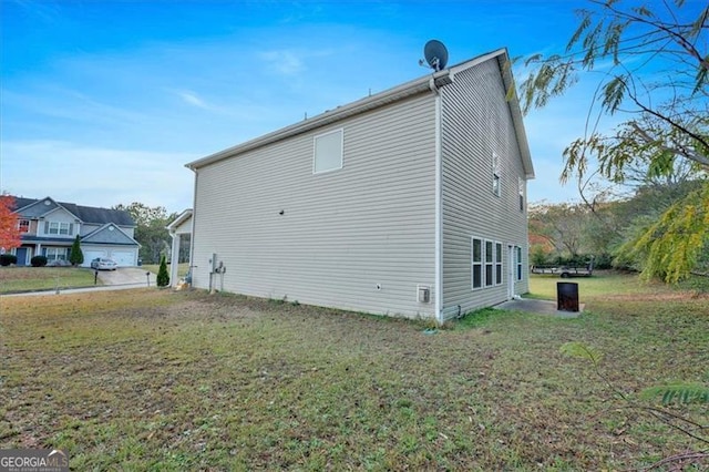 view of side of home featuring a lawn