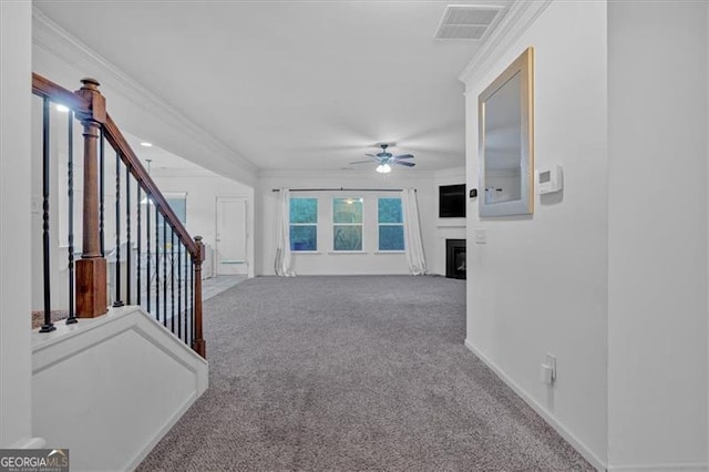 living room with ceiling fan, carpet floors, and crown molding