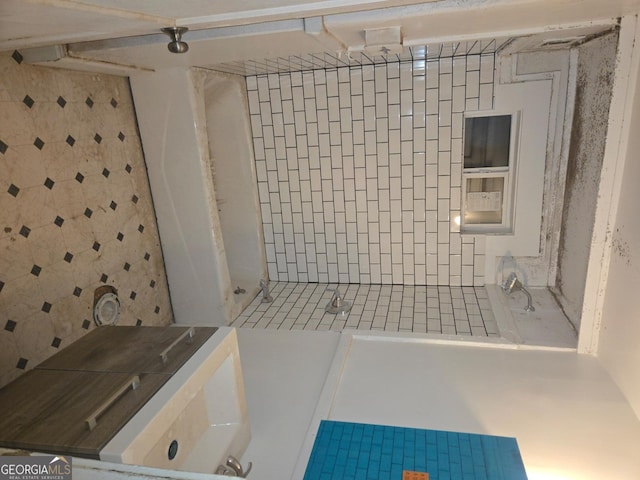 bathroom with tiled shower