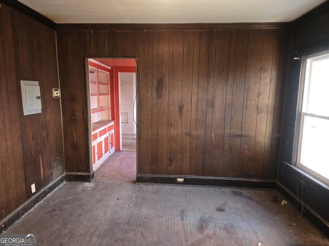 empty room featuring wood walls and dark wood-type flooring