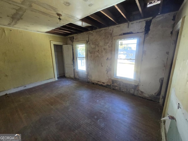 unfurnished room with dark wood-type flooring