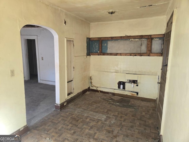 spare room featuring dark parquet flooring