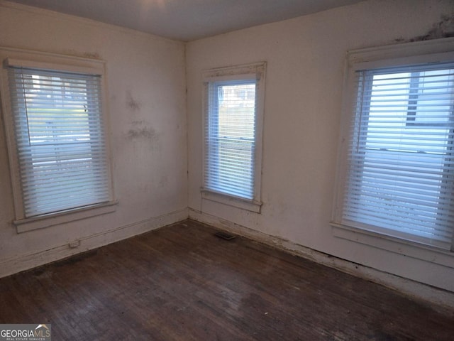 unfurnished room with dark hardwood / wood-style flooring