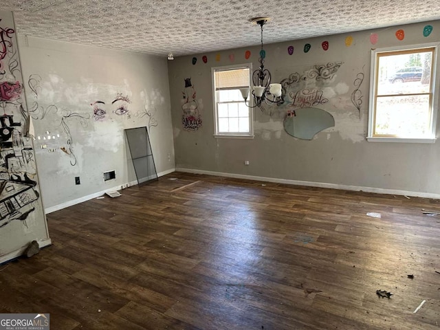 unfurnished dining area with a chandelier and dark hardwood / wood-style flooring