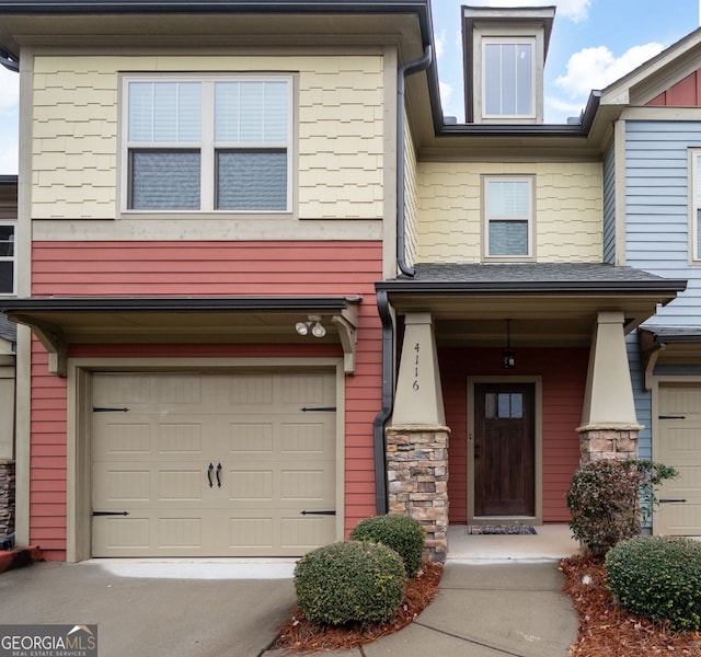 townhome / multi-family property featuring a garage