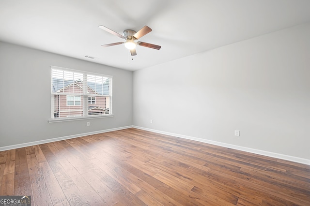 unfurnished room featuring dark hardwood / wood-style flooring and ceiling fan