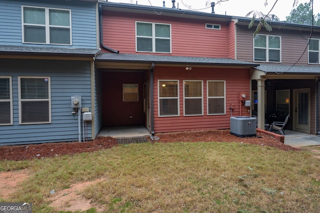 back of property featuring a yard and central AC unit