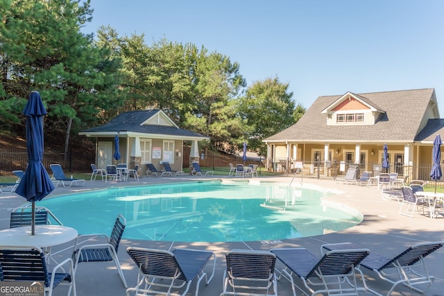 view of swimming pool featuring a patio area and an outdoor structure