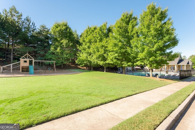 view of home's community with a yard and a playground