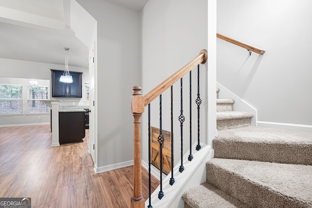 stairs featuring hardwood / wood-style floors