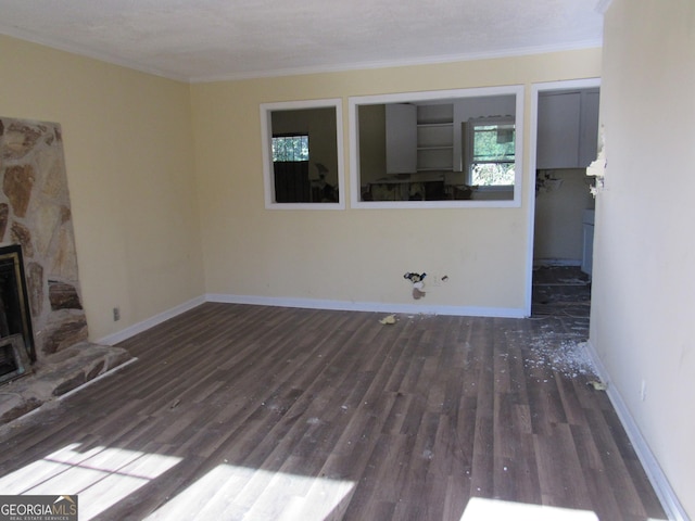 unfurnished living room with dark hardwood / wood-style floors, a fireplace, and crown molding