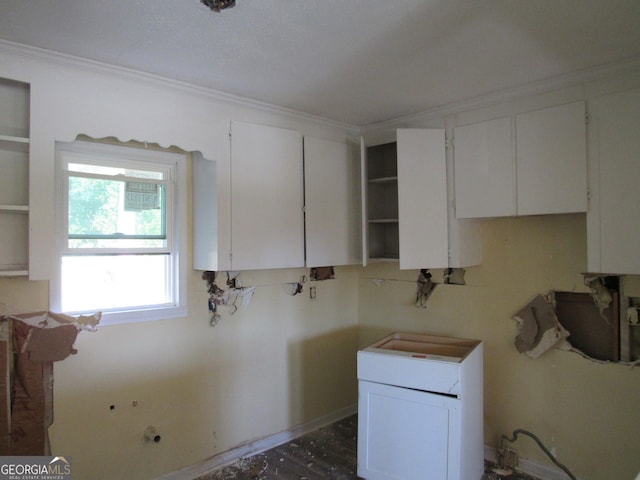 kitchen with white cabinetry and water heater